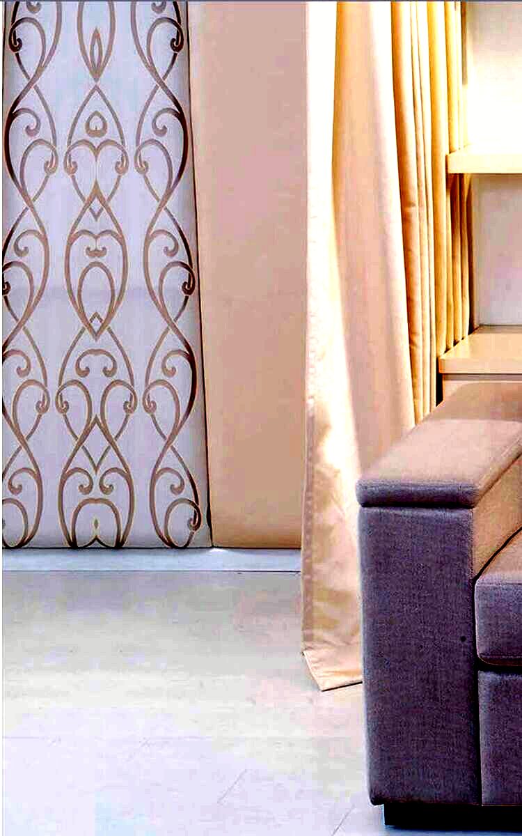 Patterned sheers layered behind full drapes